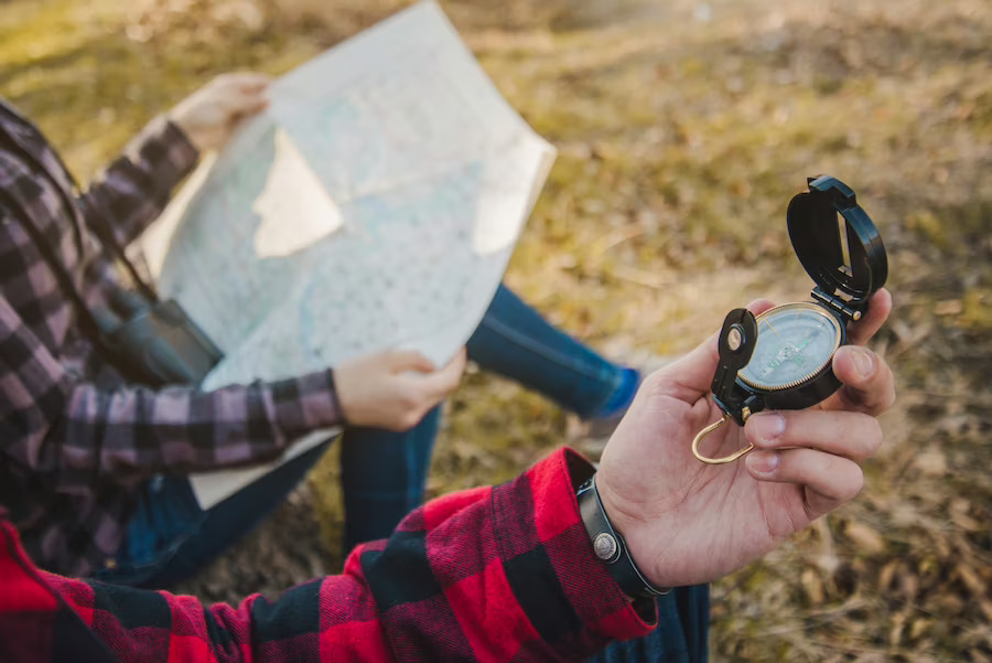 close-up-hiker-with-compass-his-hand_23-2147628872