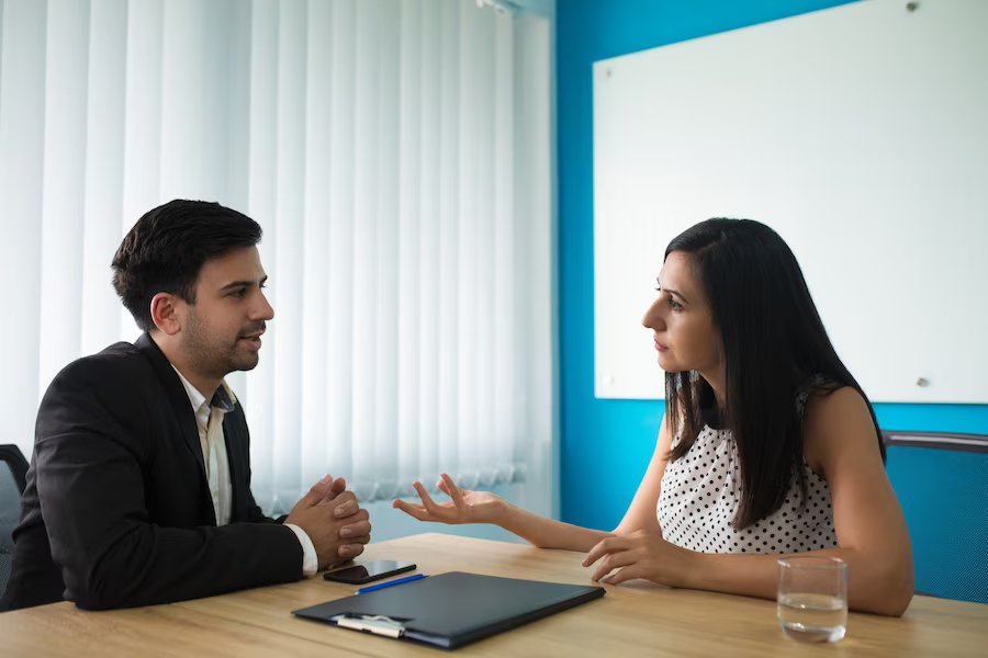 serious-businesswoman-businessman-talking-boardroom_1262-18034