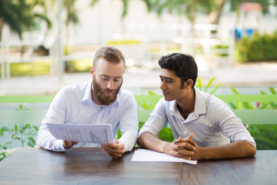 two-focused-business-men-meeting-working-outdoor-cafe_1262-16985